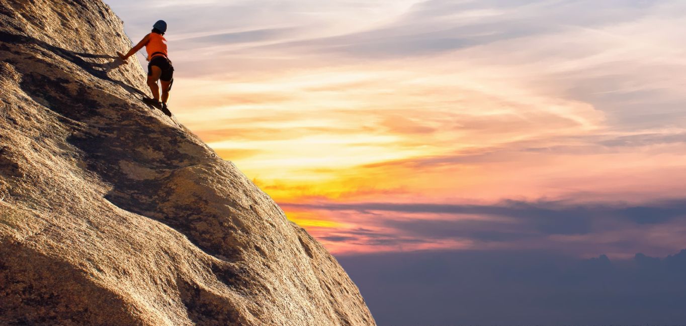 Person-Climbing-on-Mountain-During-Sunrise Person Climbing on Mountain During Sunrise