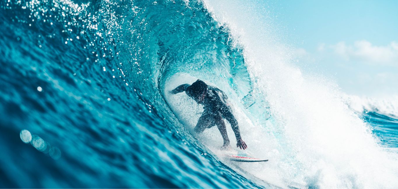 Surfer-Riding-Azure-Sea-Wave Unrecognizable energetic surfer riding azure sea wave.